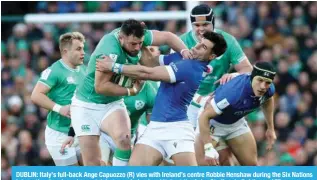  ?? ?? DUBLIN: Italy’s full-back Ange Capuozzo (R) vies with Ireland’s centre Robbie Henshaw during the Six Nations internatio­nal rugby union match between Ireland and Italy at the Aviva Stadium in Dublin. — AFP