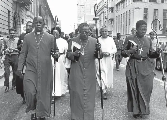  ??  ?? Bishop Mfaniseni Ndwandwe, left, with Bishop Desmond Tutu, centre, and Bishop Simeon Nkoane lead a march on Johannesbu­rg’s police headquarte­rs in 1985. Picture: Robert Tshabalala