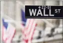  ?? Associated Press ?? American flags hang outside of the New York Stock Exchange in New York on Feb. 16.