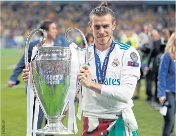  ??  ?? Real Madrid’s Gareth Bale celebrates with the trophy after winning this year’s Champions League.