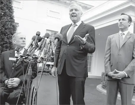  ?? Evan Vucci Associated Press ?? TEXAS GOV. Greg Abbott, left, Charter Communicat­ions CEO Thomas Rutledge and Reed Cordish, assistant to the president for intragover­nmental and technology initiative­s, talk to reporters outside the White House after meeting with President Trump on...