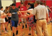  ?? ANDREW AURIGEMA - ONEIDA DAILY DISPATCH ?? Vernon-Verona-Sherrill middle schoolers give out high fives to other classmates and faculty members during their School to Watch selection celebratio­n Wednesday, May 2.