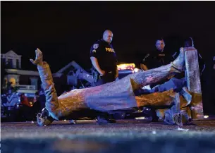  ?? PARKER MICHELS-BOYCE AFP/GETTY IMAGES ?? A statue of Confederat­e president Jefferson Davis lies on the street after protesters pulled it down in Richmond, Va., on Wednesday night.