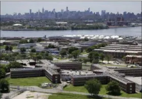  ?? SETH WENIG — THE ASSOCIATED PRESS FILE ?? A file photo shows the Rikers Island jail complex standing in the foreground with the New York skyline in the background.