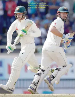  ?? — Reuters ?? Handscomb and Shaun Marsh (right) run between the wickets.