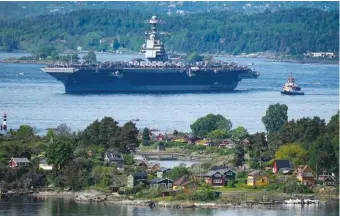  ?? JAVAD PARSA/NTB SCANPIX VIA AP ?? The American aircraft carrier USS Gerald R. Ford sails Wednesday in the Oslo Fjord, Norway, here seen from Ekebergskr­enten.