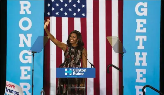  ??  ?? First lady Michelle Obama was a crowd favorite at a rally for Democratic presidenti­al nominee Hillary Clinton at George Mason University in Fairfax, Va. Recent polls have shown a tightening race between Clinton and Republican rival Donald Trump.