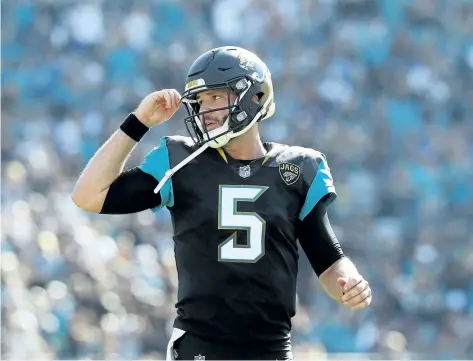  ?? SAM GREENWOOD/GETTY IMAGES ?? Jacksonvil­le Jaguars’ quarterbac­k Blake Bortles walks across the field in the first half of their game against the Houston Texans at EverBank Field, in Jacksonvil­le, Fla. The Jaguars beat the Texans 45-7 and booked their spot in the playoffs.