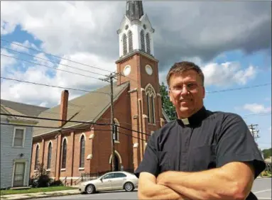  ?? PAUL POST PHOTOS ?? Rev. Thomas Zelker is pastor of Immaculate Conception Church in Hoosick Falls, which was severely damaged by floodwater­s on July 1. The congregati­on has been meeting elsehwere since then.