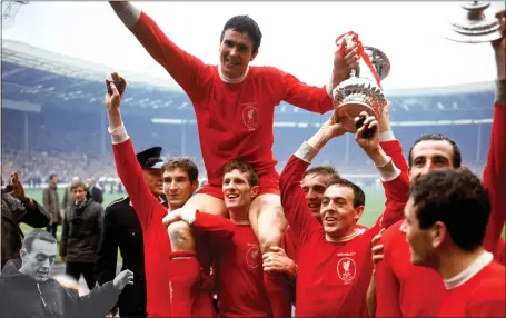  ??  ?? Ian St John holds the FA Cup as captain Ron Yeats is hoisted aloft, after Liverpool beat Leeds United 2-1 in 1965