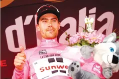  ?? — AFP photo ?? Netherland­s' Tom Dumoulin of team Sunweb celebrates the Pink Jersey of the overall leader on the podium after the 18th stage of the 100th Giro d'Italia,Tour of Italy, cycling race from Moena to Ortisei on May 25, 2017.