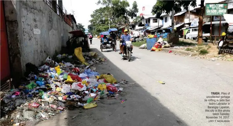  ?? (JOEY P. NACALABAN) ?? TRASH. Piles of uncollecte­d garbage lie rotting in Sitio San Isidro Labrador in Barangay Lapasan, this city in this photo taken Tuesday, November 14, 2017.