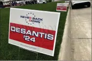  ?? TOM BEAUMONT — THE ASSOCIATED PRESS ?? Yard signs promoting Florida Gov. Ron DeSantis in 2024, financed by the super PAC promoting DeSantis for president, line the street leading up to a Republican congressio­nal fundraiser on May 13. 2023, in Sioux Center, Iowa. The super PAC, Never Back Down, is taking on the labor-intensive task of organizing support in the 2024 Iowa caucuses for DeSantis, though barred by law from coordinati­ng with the candidate.