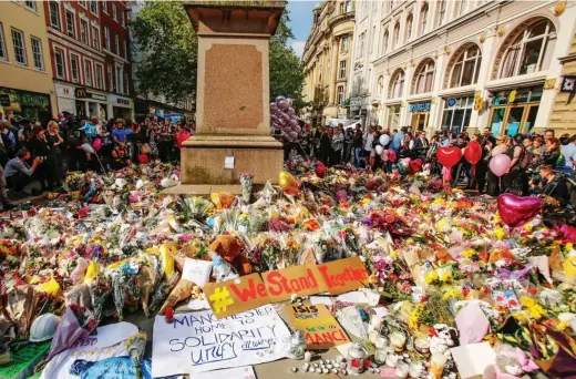  ??  ?? Tributes: Thousands of bouquets, heart shaped balloons and messages of unity cover Manchester’s St Ann’s Square yesterday