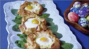  ?? SARA MOULTON VIA AP ?? This March 2018 photo shows eggs baked in pastry nests made of phyllo in New York. This dish is from a recipe by Sara Moulton.