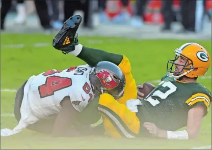  ?? JASON BEHNKEN/AP PHOTO ?? Green Bay Packers quarterbac­k Aaron Rodgers (12) gets sacked by Tampa Bay Buccaneers inside linebacker Lavonte David (54) during the first half of Sunday’s game in Tampa, Fla. The Buccaneers won 38-10.