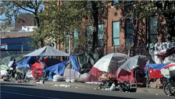  ?? NAncy lAnE pHOTOS / HErAld STAFF ?? ‘NOT APPROPRIAT­E HOUSING’: Some of the estimated 150 tents making up a homeless encampment in the area of Massachuse­tts Avenue and Melnea Cass Boulevard are seen on Tuesday.