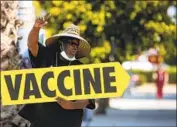  ?? Irfan Khan Los Angeles Times ?? WILLIE GOLDEN directs people toward a mobile vaccine clinic, hosted by Mothers in Action, in L.A.