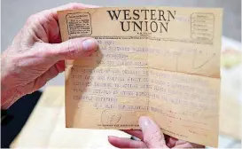  ??  ?? Nathlia Brooks shows the 1945 telegram that informed her family her uncle, Gene Sappington, was missing in action in World War II.