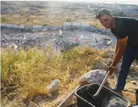  ?? (Tovah Lazaroff) ?? YONATAN DREINOF mixes cement at a cornerston­e-laying ceremony yesterday in Beit El, where his father, contractor Meir Dreinof, plans to rebuild the apartments that were torn down the previous day.