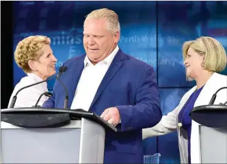  ?? FRANK GUNN/The Canadian Press ?? Ontario Liberal Leader Kathleen Wynne, left, shakes hands with Ontario NDP Leader Andrea Horwath, right, behind Ontario Progressiv­e Conservati­ve Leader Doug Ford following the end of the third and final televised debate of the provincial election...