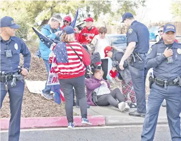  ??  ?? Pro-wall demonstrat­or Melinda Oporto lies on the ground after collapsing at a rally in front of the San Ysidro Border Patrol Station in San Ysidro, California. — AFP photo