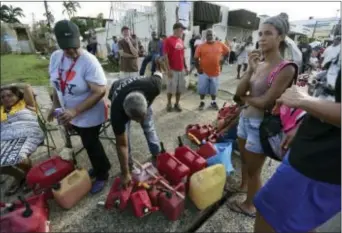  ?? CARLOS GIUSTI — THE ASSOCIATED PRESS ?? Hundreds of people wait in line since the morning to buy gasoline three days after the impact of Hurricane Maria in Carolina, Puerto Rico, Saturday. A humanitari­an crisis grew Saturday in Puerto Rico as towns were left without fresh water, fuel, power...