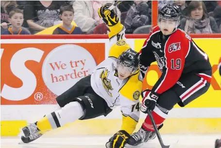  ?? JEAN LEVAC/OTTAWA CITIZEN ?? Joseph Blandisi of the 67’s, right, hits Alex Carnevale of the Sarnia Sting during the first period at Scotiabank Place Friday night.