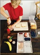  ?? COURTESY OF KATIE WORKMAN ?? Charlie Freilich, son of food writer Katie Workman, preparing his school lunch in New York. If you have a pint-size vegetarian at home, there’s no reason that packed lunches for school can’t be as nourishing, delicious and kid-friendly as any other.