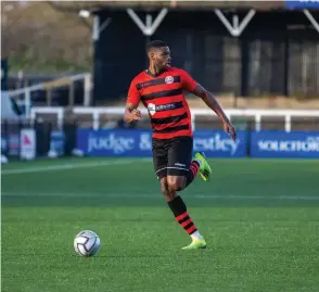  ??  ?? Nathan Blissett dribbles up the pitch and looks for a pass.