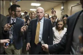 ?? AP PHOTO ?? Sen. John McCain, R-Ariz., is surrounded by reporters as he and other lawmakers arrive for a vote, at the Capitol in Washington yesterday.