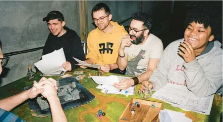  ?? OK MCCAUSLAND/THE NEW YORK TIMES ?? Caleb Cummings, from left, Maxim Allen, Victor Ocasio and Amya Williams play a game of Dungeons & Dragons on April 4 at the Brooklyn Strategist.