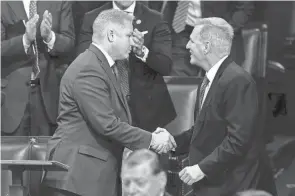  ?? ALEX BRANDON/AP ?? Rep. Warren Davidson, R-troy, shakes hands with Rep. Kevin Mccarthy, R- Calif., as the House meets to elect a speaker on Jan. 4. Before the motion to vacate on Tuesday, House lawmakers voted on whether to table the measure to altogether. Davidson voted against Mccarthy’s removal Tuesday.