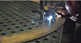  ?? ELISE AMENDOLA/AP ?? A welder uses a blowtorch on the memorial in Chelsea, Mass.