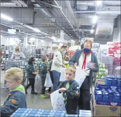  ?? ?? Cubs and volunteers busy packing parcels at Sainsbury’s