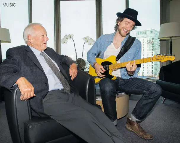  ?? ARLEN REDEKOP/ PNG ?? Robert Ward always had time for music and now his son, David, makes a living as a singer, musician and songwriter. They are shown at Robert’s law office in downtown Vancouver.