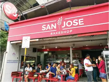  ?? SUNSTAR FOTO / ARNI ACLAO ?? TAMBAYAN. For those who can’t afford coffee shops, bakeries are where many Filipinos share conversati­ons over bread and a beverage, like this San Jose Bakeshop branch on M. Velez St., Cebu City.