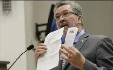  ?? AP PHOTO/RICH PEDRONCELL­I ?? In this Nov. 28 file photo, Assemblyma­n Ken Cooley, D-Rancho Cordova, displays state and legislativ­e policies concerning sexual harassment during a committee hearing tasked with revising the California Assembly’s sexual harassment policies in Sacramento.