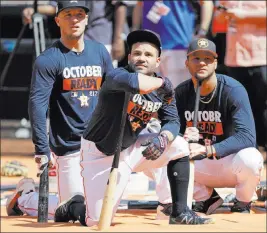  ?? David J. Phillip ?? The Associated Press Houston Astros second baseman Jose Altuve, center, waits to bat with third baseman Alex Bregman, left, and first baseman Yuli Gurriel during practice Wednesday in Houston.