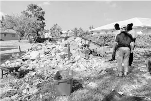  ?? COURTESY PHOTOS ?? New neighbors came to help after the Zamir family’s moving truck crashed, destroying their possession­s.