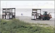  ?? JENNIFER REYNOLDS/THE GALVESTON COUNTY DAILY NEWS VIA AP ?? Park board crews move the lifeguard towers off the beach near 19th Street in Galveston, Texas on Monday as they prepare for a possible impact from Tropical Storms Marco and Laura.