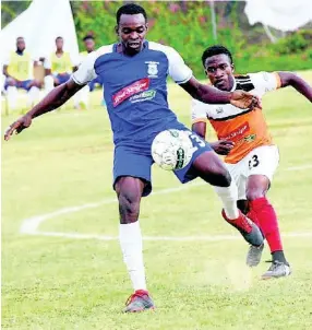  ?? FILE ?? Rondell Morris (left) of Reno and Nickoy Christian of Dunbeholde­n vie for the ball during their Red Stripe Premier League match on Sunday, March 10, 2019.