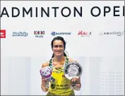  ?? AFP ?? PV Sindhu poses on the podium after her victory on Sunday.