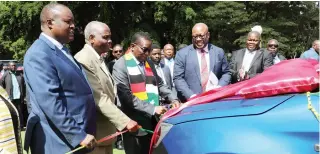  ?? — ?? President Mnangagwa cuts the ribbon while flanked by Local Government and Public Works Minister Winston Chitando (second from right), Permanent Secretary John Basera (far right), Chiefs Council president Chief Mtshane Khumalo (second from left) and Chiefs Council deputy president Chief Fortune Charumbira during the handover of replacemen­t vehicles to chiefs in Harare yesterday. Picture: Innocent Makawa