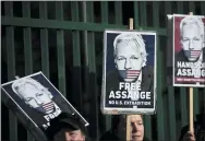  ?? MATT DUNHAM — THE ASSOCIATED PRESS ?? Supporters of Julian Assange hold placards as they protest on the second day of a week of opening arguments for the extraditio­n of Wikileaks founder Julian Assange outside Belmarsh Magistrate­s’ Court in south east London, Tuesday.