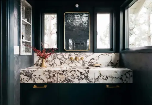  ??  ?? Ensuite bathroom Reflected in the brass mirror from Rejuvenati­on are the zellige tiles in ‘Battle Armor’ from Clé that have been used in the shower. Portola Paints & Glazes’ Roman Clay in ‘Quell’ covers the walls, allowing the bespoke Calacatta Viola vanity unit to shine. The taps are from Waterworks Main bedroom Elspeth has kept the décor simple here, with plain white panelled walls and a vintage wooden bed frame topped with Urban
Outfitters bedding. The bedside lamp is from Blu Dot See Stockists page for details