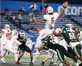  ?? JASON GETZ FOR THE AJC ?? Milton running back Jordan McDonald (5), who made the All-AJC Class 7A team, attempts a pass against Collins Hill in the state championsh­ip game Dec. 11.