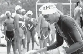  ?? ALGERINA PERNA/BALTIMORE SUN ?? Marvin A. Thorpe II, right, and his 4M Swim Club Swimmers take part in the 7th Annual Swim Across America event at Meadowbroo­k Aquatic Center.