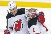  ?? GENE J. PUSKAR THE ASSOCIATED PRESS ?? New Jersey Devils forward Brian Boyle (left) had a hat trick against the Pittsburgh Penguins on Hockey Fights Cancer day.