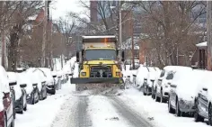  ?? FRED SQUILLANTE/ COLUMBUS DISPATCH ?? Have agencies saved money on snow removal costs this winter?
A snow plow cleans West 10th Ave., a side street near Ohio State University, in Columbus, on Feb. 2, 2021.